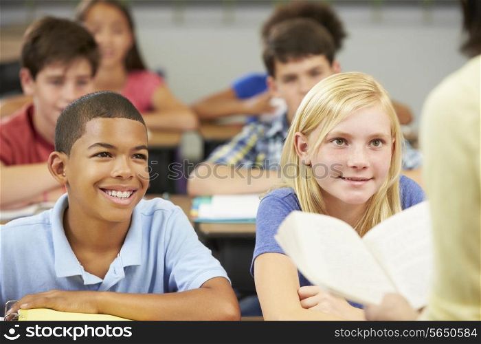 Teacher Reading To Class Of Pupils