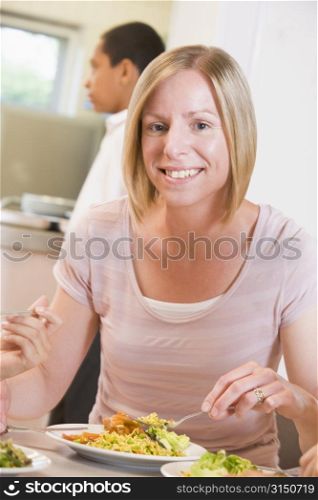 Teacher sitting at cafeteria table eating lunch