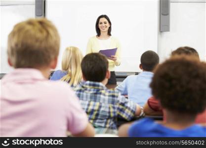 Teacher Standing In Front Of Class Of Pupils