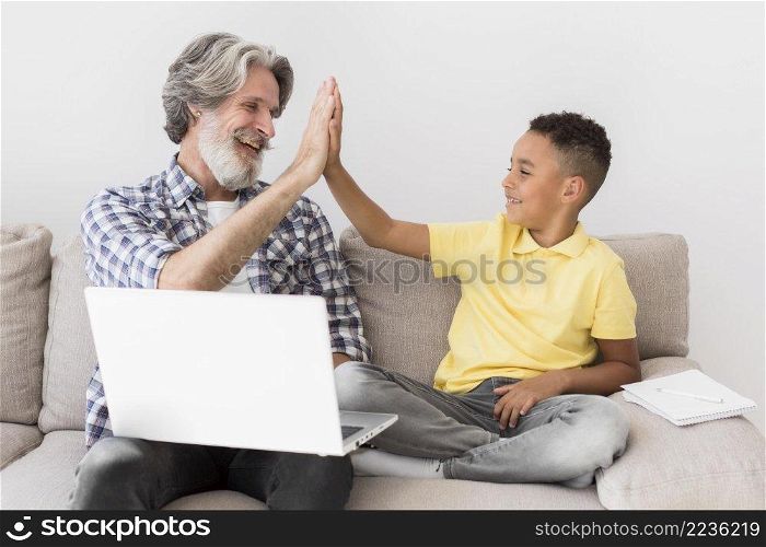 teacher student high fiving couch