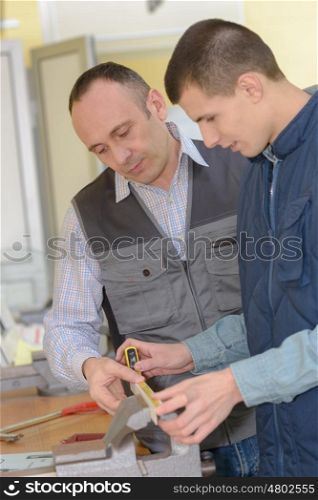teacher talking to student using a tool