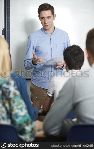 Teacher Talking To Teenage Pupils In Class