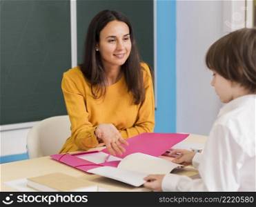 teacher talking with her student class