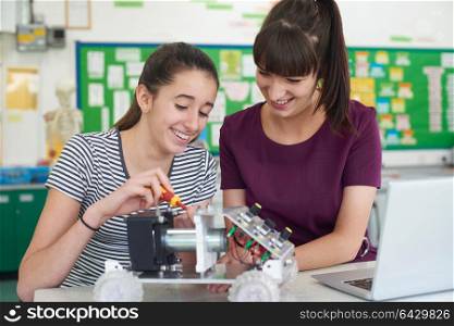 Teacher With Female Pupil Studying Robotics In Science Lesson