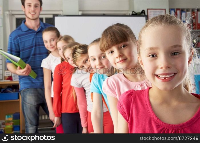 Teacher with line up of children in class