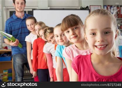 Teacher with line up of children in class