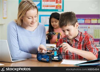 Teacher With Pupils In Science Lesson Studying Robotics
