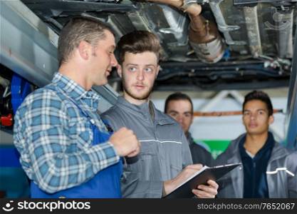 teacher with student in mechanics class