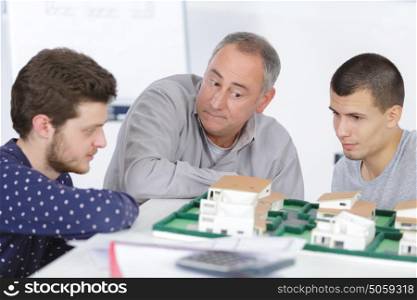 teacher with students in architecture school