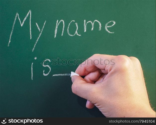 Teacher writing on green chalkboard: My name is