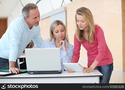 Teachers and teenage girl in front of computer