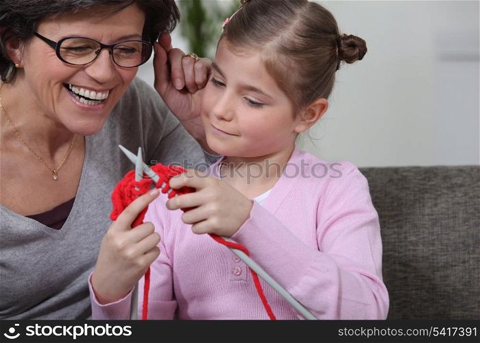 Teaching her daughter how to knit.