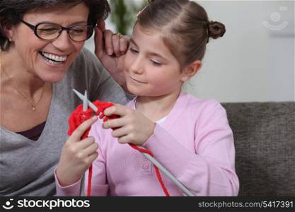Teaching her daughter how to knit.