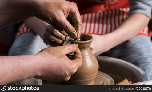 Teaching pottery to children. The teacher gives a master class in modeling. children&rsquo;s pottery studio