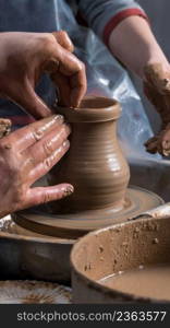 Teaching pottery to children. The teacher gives a master class in modeling. children’s pottery studio