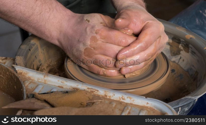 Teaching pottery to children. The teacher gives a master class in modeling. children&rsquo;s pottery studio