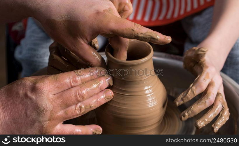 Teaching pottery to children. The teacher gives a master class in modeling. children&rsquo;s pottery studio