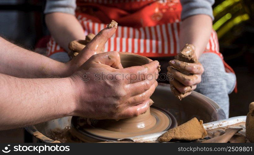 Teaching pottery to children. The teacher gives a master class in modeling. children’s pottery studio