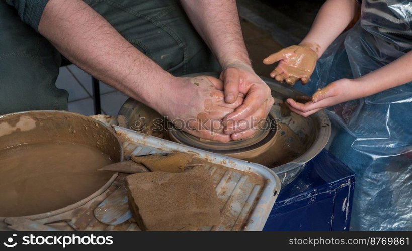 Teaching pottery to children. The teacher gives a master class in modeling. children’s pottery studio