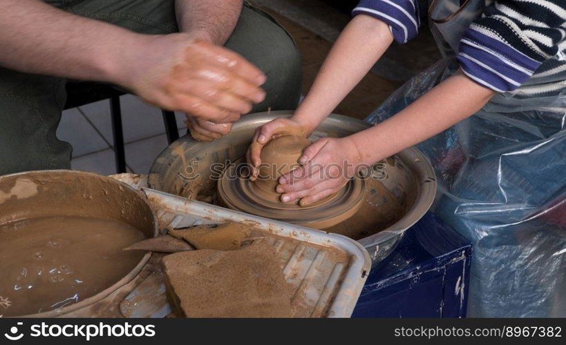 Teaching pottery to children. The teacher gives a master class in modeling. children&rsquo;s pottery studio