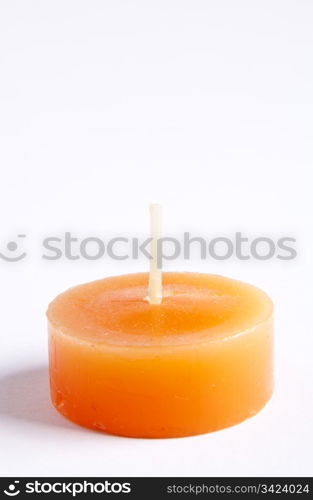 Tealight candles in bright orange against a plain background
