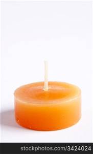 Tealight candles in bright orange against a plain background