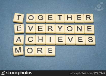 TEAM acronym  together everyone achieves more , teamwork motivation concept, word abstrat in ivory letter tiles against textured handmade paper, business and education concept