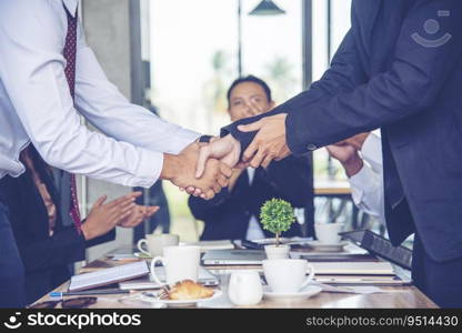 Team Business Partners shaking hands together to Greeting Start up new project. Shakehand Teamwork Partnership outside office modern city background. Businessman handshake together.  Business concept