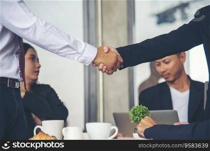 Team Business Partners shaking hands together to Greeting Start up small business in meeting room. Shakehand teamwork partners at modern office handshake together. Business mergers and acquisitions
