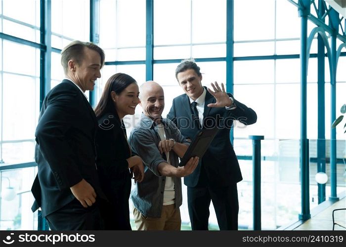 Team business people using tablet discussing online project or making conference video call together at modern office,Business people attending videoconference meeting.