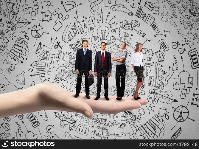 Team concept. Conceptual image of business team on standing on palm