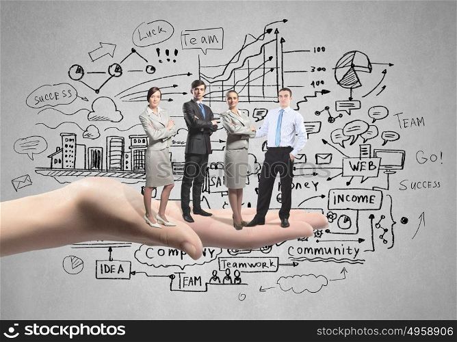 Team concept. Conceptual image of business team on standing on palm