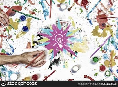 Team creative work. Top view of hands drawing creative concept with paints