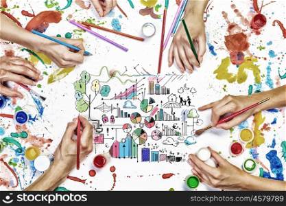 Team creative work. Top view of people hand drawing business creative concept with paints