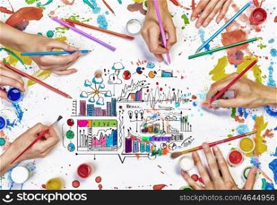 Team creative work. Top view of people hand drawing business creative concept with paints