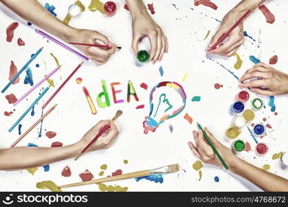 Team creative work. Top view of people hand drawing business creative concept with paints