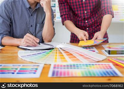 team interior designer drawing a new project using graphic computer and choosing Color swatch samples in modern Creative studio