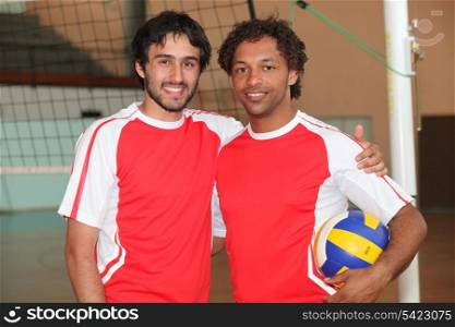 Team mates stood with volley ball