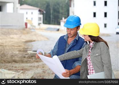 Team of architects checking plans on site