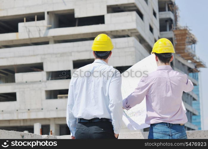 Team of architects people in group on construciton site check documents and business workflow