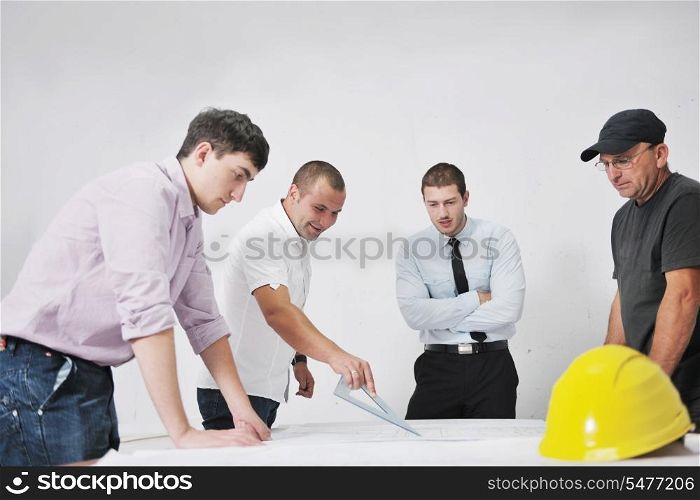 Team of architects people in group on construciton site check documents and business workflow