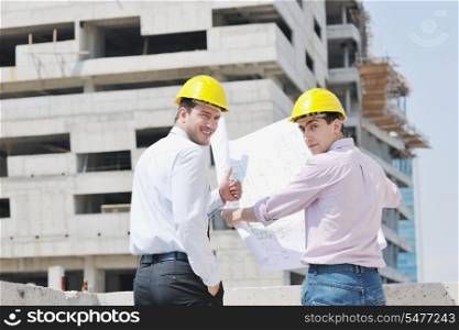 Team of architects people in group on construciton site check documents and business workflow