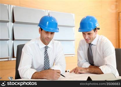 Team of architects working on construction plan