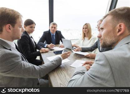 Team of business people at meeting in office discuss contract terms. Business people at meeting