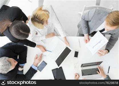 Team of business people at meeting in office discuss financial documents and statistics data. Business people at meeting