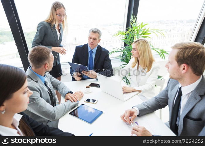 Team of business people at meeting in office discuss financial documents and statistics data. Business people at meeting