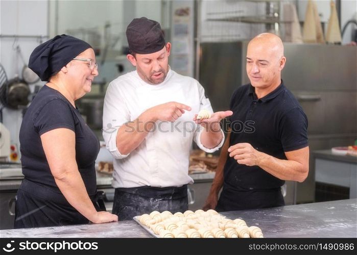 Team of Confectioners talking about the croissant recipe .. Team of Confectioners talking about the croissant recipe