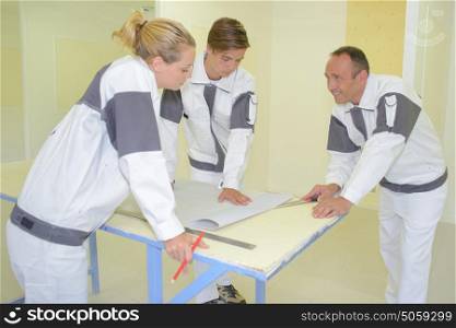 Team of decorators in discussion around a table