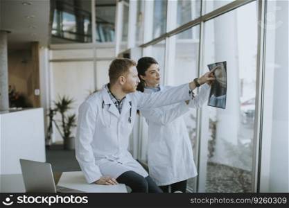 Team of doctors examining x-ray image in the office