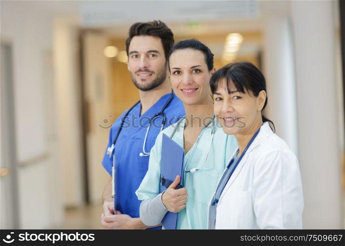 team of doctors standing in the hospital corridor